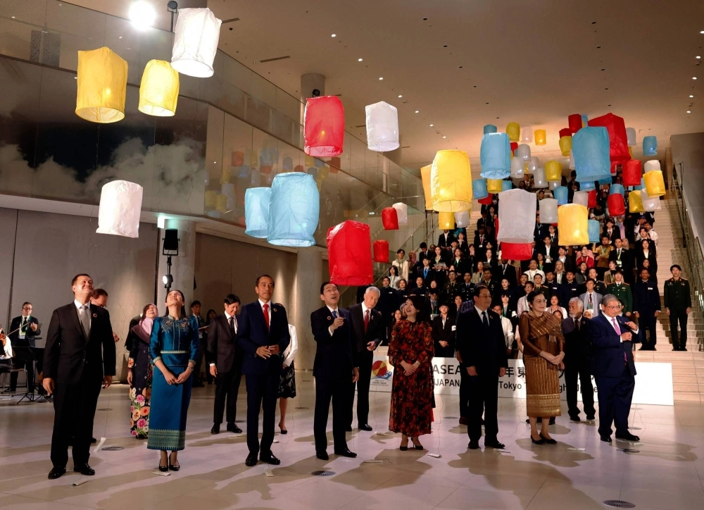 ASEAN leaders and their spouses release paper lanterns into the air with students from ASEAN member states during a lighting ceremony for the ASEAN-Japan Commemorative Summit at Azabudai Hills in Tokyo on Sunday. ASEAN leaders and their spouses release paper lanterns into the air with students from ASEAN member states during a lighting ceremony for the ASEAN-Japan Commemorative Summit at Azabudai Hills in Tokyo on Sunday.