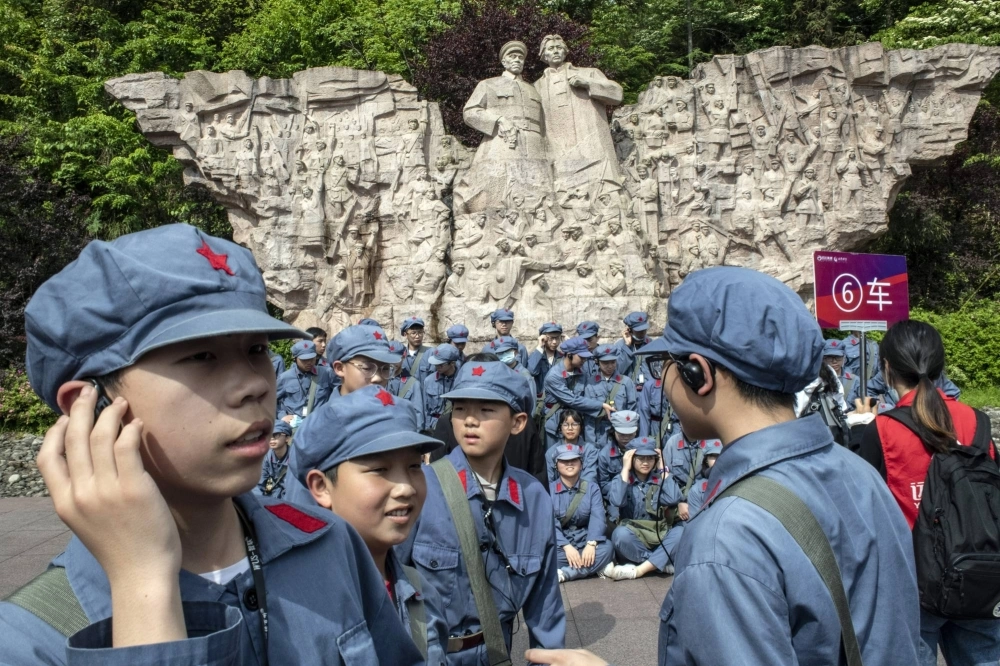 Children dressed as Chinese Red Army soldiers in front of a statue of Mao Zedong at the Revolution Museum in Jinggangshan, China, in 2021 Children dressed as Chinese Red Army soldiers in front of a statue of Mao Zedong at the Revolution Museum in Jinggangshan, China, in 2021