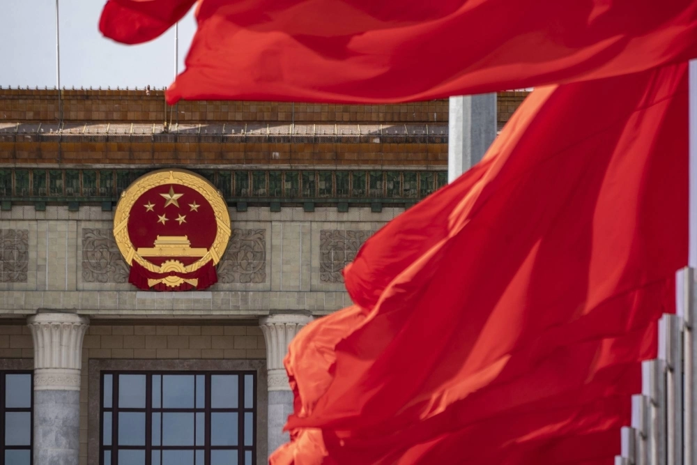 The Chinese national emblem and flags at the Great Hall of the People in Beijing on Oct. 18. The Chinese national emblem and flags at the Great Hall of the People in Beijing on Oct. 18.
