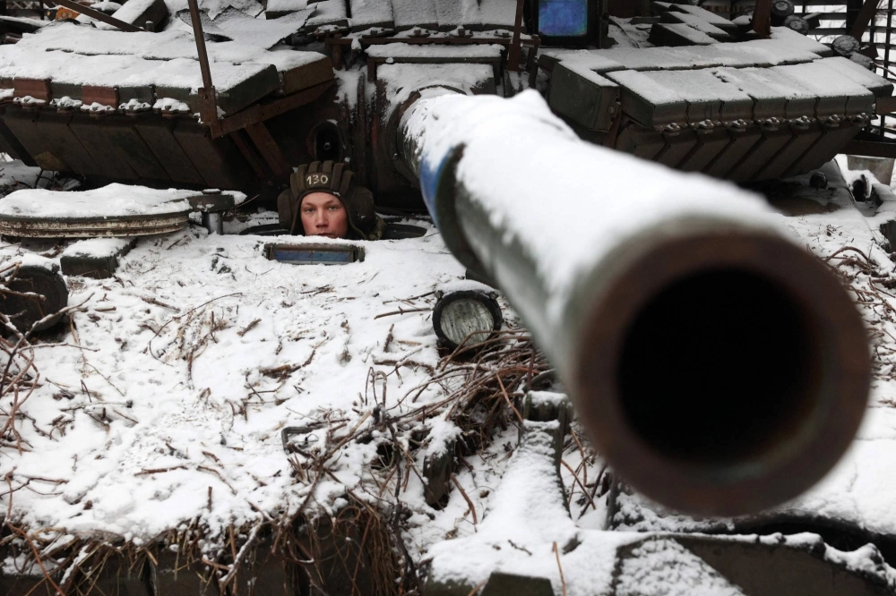 A Ukrainian soldier looks out from a tank as he holds his position near to the town of Bakhmut, in Ukraine's Donetsk region, on Dec. 13. A Ukrainian soldier looks out from a tank as he holds his position near to the town of Bakhmut, in Ukraine's Donetsk region, on Dec. 13.