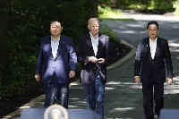 South Korean President Yoon Suk-yeol, U.S. President Joe Biden and Prime Minister Fumio Kishida arrive for a news conference during a trilateral summit at Camp David, Maryland, in the United States on Aug. 18. The three countries drew closer in 2023 amid growing concerns over North Korea and China. | Bloomberg