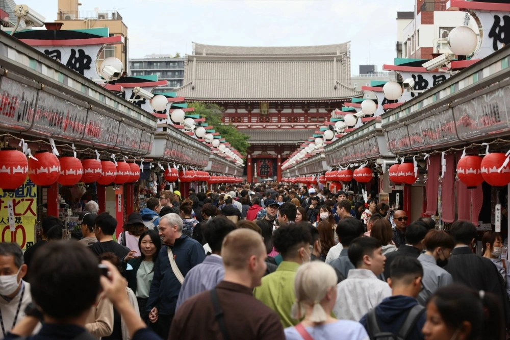 The Nakamise-dori shopping street in Tokyo’s Asakusa district. Foreign tourists returned in droves in 2023, spurring fresh concerns of overtourism. The influx of visitors came after Japan downgraded the status of COVID-19 to a lower-risk disease category, effectively ending all pandemic-related restrictions.
The Nakamise-dori shopping street in Tokyo’s Asakusa district. Foreign tourists returned in droves in 2023, spurring fresh concerns of overtourism. The influx of visitors came after Japan downgraded the status of COVID-19 to a lower-risk disease category, effectively ending all pandemic-related restrictions.