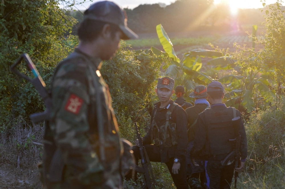 People's Liberation Army forces walk near the Sagaing Region in Myanmar on Nov. 23. People's Liberation Army forces walk near the Sagaing Region in Myanmar on Nov. 23.