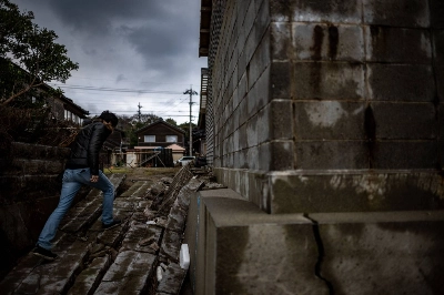 Masaki Sato, who owns an 85-year-old property in the Akasaki district of Shika, Ishikawa Prefecture, walks in the district on Saturday after a major earthquake struck the Noto region on New Year's Day. Masaki Sato, who owns an 85-year-old property in the Akasaki district of Shika, Ishikawa Prefecture, walks in the district on Saturday after a major earthquake struck the Noto region on New Year's Day.