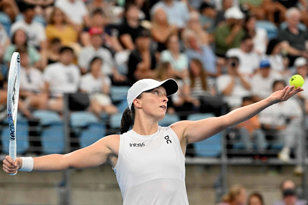 Poland's Iga Swiatek serves against Germany's Angelique Kerber during their women's singles final match at the United Cup tennis event in Sydney on Sunday. Poland's Iga Swiatek serves against Germany's Angelique Kerber during their women's singles final match at the United Cup tennis event in Sydney on Sunday.