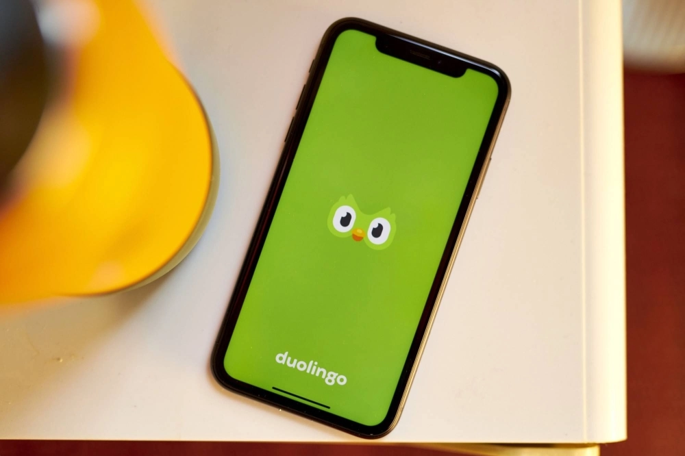 The logo of language-learning app, Duolingo, on a smartphone  The logo of language-learning app, Duolingo, on a smartphone