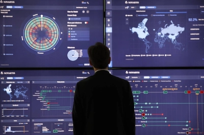 An employee looks at data on screens in the high-tech command center at the Novartis AG campus in Basel, Switzerland. An employee looks at data on screens in the high-tech command center at the Novartis AG campus in Basel, Switzerland.