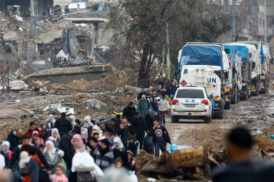 Palestinians fleeing northern Gaza move southward as trucks carrying aid and fuel head toward north Gaza during a temporary truce between Israel and Hamas, near Gaza City on Nov. 27. Palestinians fleeing northern Gaza move southward as trucks carrying aid and fuel head toward north Gaza during a temporary truce between Israel and Hamas, near Gaza City on Nov. 27.