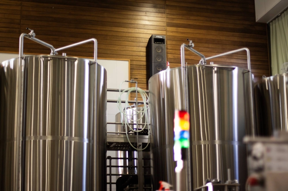 Where children once played tag in Mosetsuri Elementary School's gymnasium, Brassiere Knot's towering vats for brewing and fermenting now stand. Where children once played tag in Mosetsuri Elementary School's gymnasium, Brassiere Knot's towering vats for brewing and fermenting now stand.