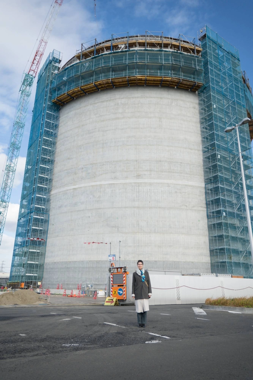Conservation North’s Michelle Connolly stands in front of an under-construction storage tank at Sumitomo Corp.’s Sendai biomass power plant. Conservation North’s Michelle Connolly stands in front of an under-construction storage tank at Sumitomo Corp.’s Sendai biomass power plant.