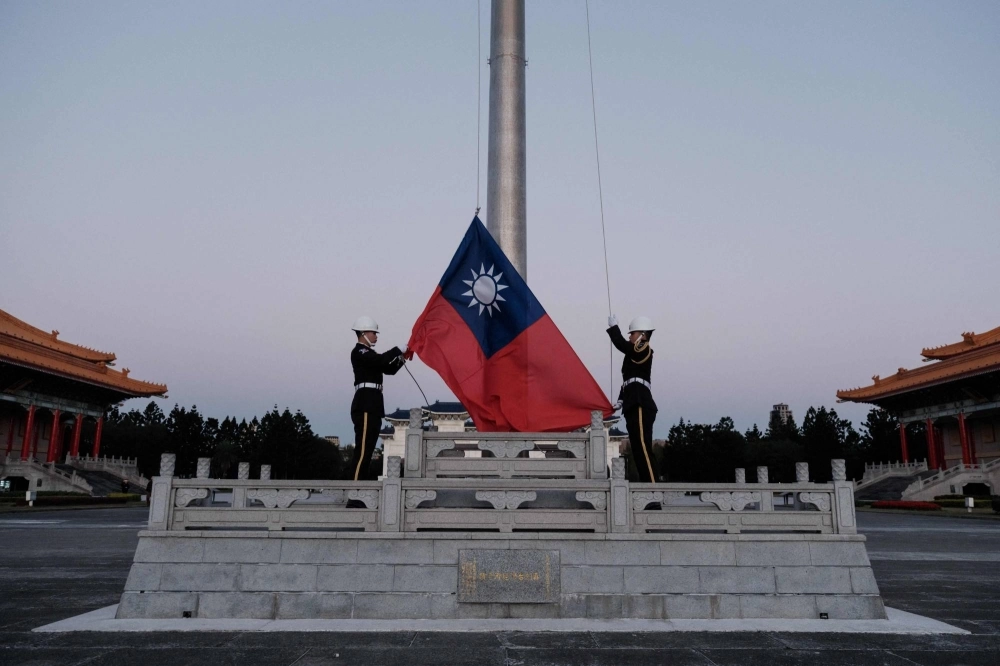 Guards raise Taiwan's national flag on the Democracy Boulevard at the Chiang Kai-shek Memorial Hall in Taipei on Sunday. Guards raise Taiwan's national flag on the Democracy Boulevard at the Chiang Kai-shek Memorial Hall in Taipei on Sunday.