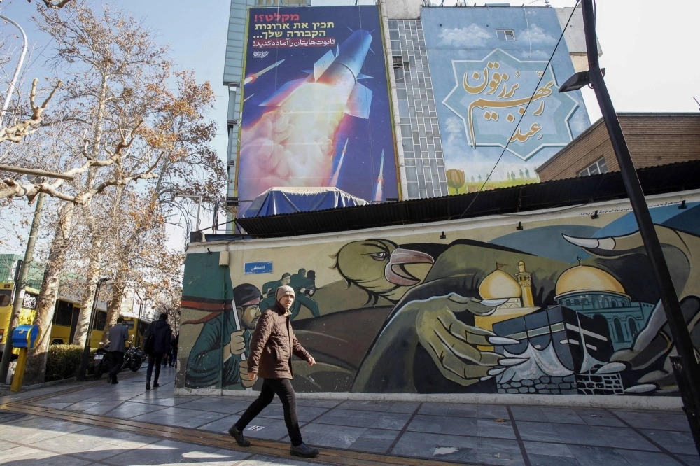 A large billboard depicting an Iranian missile with a phrase in Persian that reads "prepare your coffins" on the side of a building in Tehran on Tuesday, after overnight missile attacks by Iran on multiple targets in Syria and in Iraq's autonomous Kurdistan region. A large billboard depicting an Iranian missile with a phrase in Persian that reads "prepare your coffins" on the side of a building in Tehran on Tuesday, after overnight missile attacks by Iran on multiple targets in Syria and in Iraq's autonomous Kurdistan region.