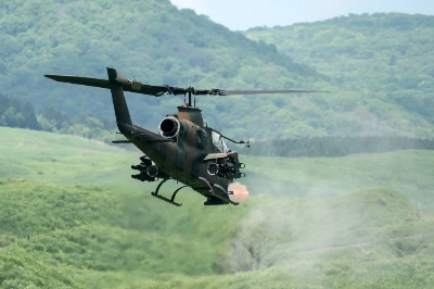 A Ground Self-Defense Force AH-1S Cobra attack helicopter fires ammunition during a live-fire exercise in Gotemba, Shizuoka Prefecture, in May 2022. A Ground Self-Defense Force AH-1S Cobra attack helicopter fires ammunition during a live-fire exercise in Gotemba, Shizuoka Prefecture, in May 2022.