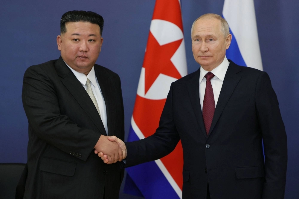 Russian President Vladimir Putin and North Korean leader Kim Jong Un shake hands during their meeting at the Vostochny Cosmodrome in Russia's Amur region on Sept. 13. Russian President Vladimir Putin and North Korean leader Kim Jong Un shake hands during their meeting at the Vostochny Cosmodrome in Russia's Amur region on Sept. 13.