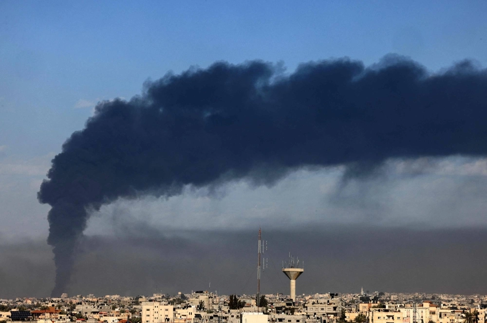 Smoke billows over Khan Yunis in the southern Gaza Strip during the Israeli bombardment on Sunday. Smoke billows over Khan Yunis in the southern Gaza Strip during the Israeli bombardment on Sunday.