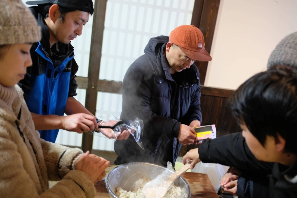 Toshiya Ikehata (center) helps prepare rice balls at a community kitchen in Wajima, Ishikawa Prefecture, on Jan. 7. Ikehata runs a fine-dining restaurant in the city, which was among the hardest-hit areas in the Noto Peninsula earthquake. Toshiya Ikehata (center) helps prepare rice balls at a community kitchen in Wajima, Ishikawa Prefecture, on Jan. 7. Ikehata runs a fine-dining restaurant in the city, which was among the hardest-hit areas in the Noto Peninsula earthquake.