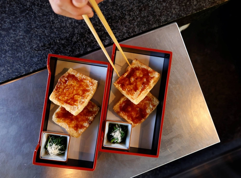 A chef prepares a tofu-based dish in Tokyo. Plant-rich and balanced diets that rely less on meat are not only healthy but also friendly to the planet. A chef prepares a tofu-based dish in Tokyo. Plant-rich and balanced diets that rely less on meat are not only healthy but also friendly to the planet.