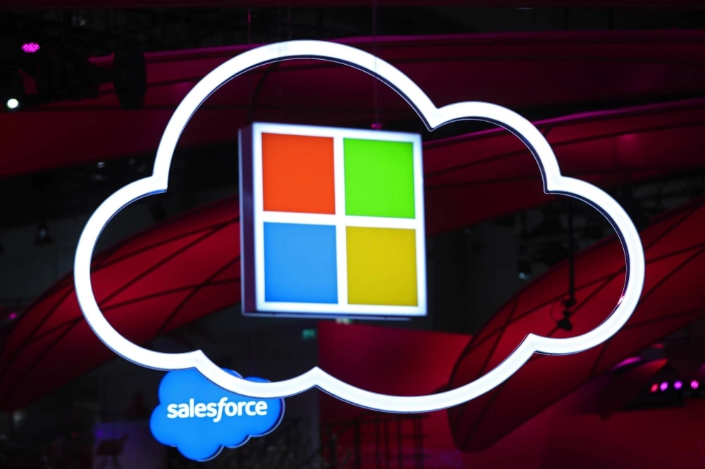 The Microsoft logo hangs beside an illuminated iCloud icon at the CeBIT 2017 tech fair in Hannover, Germany. The Microsoft logo hangs beside an illuminated iCloud icon at the CeBIT 2017 tech fair in Hannover, Germany.