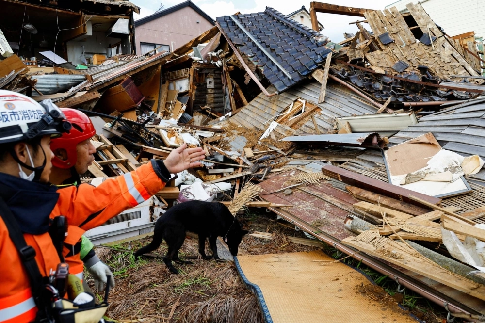 Rescue workers look for missing people in collapsed houses in the aftermath of the  earthquake that struck Wajima, Ishikawa Prefecture, and the surrounding areas on Jan. 1.   Rescue workers look for missing people in collapsed houses in the aftermath of the  earthquake that struck Wajima, Ishikawa Prefecture, and the surrounding areas on Jan. 1.