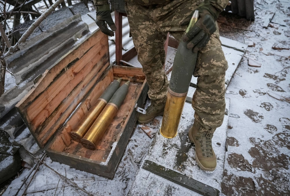 A Ukrainian serviceman prepares shells to fire a L119 howitzer toward Russian troops from a position near Bakhmut in the Donetsk region, Ukraine, on Jan. 25. A Ukrainian serviceman prepares shells to fire a L119 howitzer toward Russian troops from a position near Bakhmut in the Donetsk region, Ukraine, on Jan. 25.