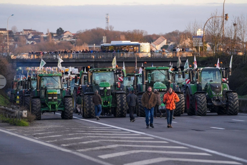 Tractors block the A6 highway during a protest by French farmers in the Chilly-Mazarin district of Paris on Wednesday.  Tractors block the A6 highway during a protest by French farmers in the Chilly-Mazarin district of Paris on Wednesday.