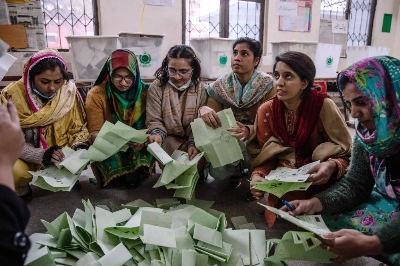 Officials count ballots at a polling station in Lahore, Pakistan, on Thursday. Officials count ballots at a polling station in Lahore, Pakistan, on Thursday.