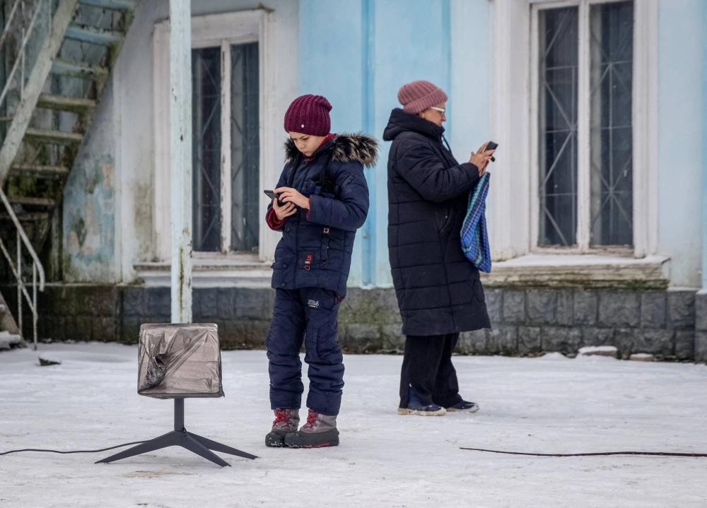 Local residents use a Starlink terminal in Chasiv Yar, Donetsk region, Ukraine, on Jan. 31, 2023.  Local residents use a Starlink terminal in Chasiv Yar, Donetsk region, Ukraine, on Jan. 31, 2023.