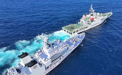 This frame grab from handout video released by the Philippine Coast guard on Feb. 11 shows a Chinese coast guard vessel (front R) blocking and sailing past Philippine coast guard ship BRP Teresa Magbanua (back L) near Scarborough Shoal, in the disputed South China Sea.  This frame grab from handout video released by the Philippine Coast guard on Feb. 11 shows a Chinese coast guard vessel (front R) blocking and sailing past Philippine coast guard ship BRP Teresa Magbanua (back L) near Scarborough Shoal, in the disputed South China Sea.