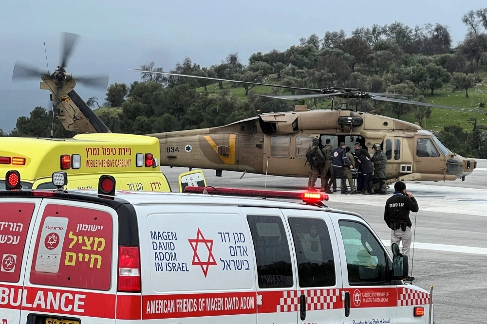 Israeli officials evacuate a person who was injured by a rocket fired from Lebanon, in Safed, northern Israel, on Wednesday. Israeli officials evacuate a person who was injured by a rocket fired from Lebanon, in Safed, northern Israel, on Wednesday.