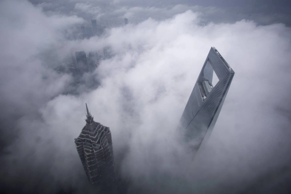 Shanghai's financial district under heavy rain. China's economy has slowed down, with some pointing to a possible balance sheet recession. Shanghai's financial district under heavy rain. China's economy has slowed down, with some pointing to a possible balance sheet recession.