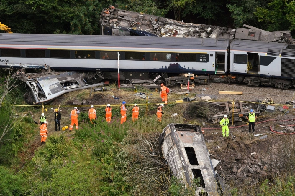 Emergency services inspect the scene following the derailment of the ScotRail train near Stonehaven, Scotland, on Aug. 13, 2020. Emergency services inspect the scene following the derailment of the ScotRail train near Stonehaven, Scotland, on Aug. 13, 2020.