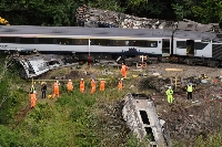 Emergency services inspect the scene following the derailment of the ScotRail train near Stonehaven, Scotland, on Aug. 13, 2020. | Bloomberg