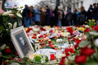 People lay flowers and candles at a memorial in front of the Russian Embassy in Berlin on Sunday, following the death of the Kremlin's most prominent critic Alexei Navalny in an Arctic prison. People lay flowers and candles at a memorial in front of the Russian Embassy in Berlin on Sunday, following the death of the Kremlin's most prominent critic Alexei Navalny in an Arctic prison.