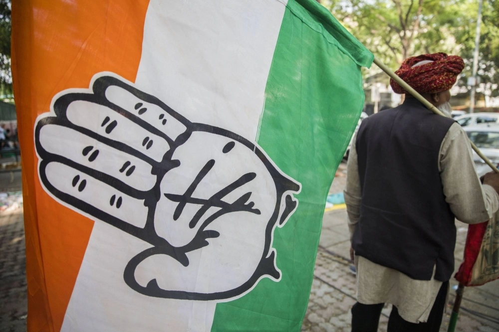 A supporter carries an Indian National Congress Party flag outside the party's headquarters in New Delhi in 2019. A supporter carries an Indian National Congress Party flag outside the party's headquarters in New Delhi in 2019.