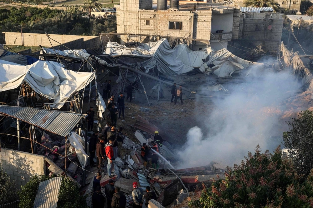 Members of the Palestinian civil defense extinguish a fire in a building following Israeli bombardments east of Rafah in the southern Gaza Strip on Monday. Members of the Palestinian civil defense extinguish a fire in a building following Israeli bombardments east of Rafah in the southern Gaza Strip on Monday.