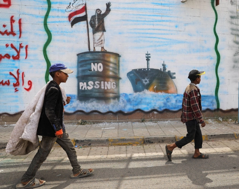 Graffiti painted on a wall of the Saudi Arabian embassy in Sanaa depicts a Houthi fighter stopping an Israeli ship off the coast of Yemen. The group has been targeting ships in the Red Sea since November. Graffiti painted on a wall of the Saudi Arabian embassy in Sanaa depicts a Houthi fighter stopping an Israeli ship off the coast of Yemen. The group has been targeting ships in the Red Sea since November.