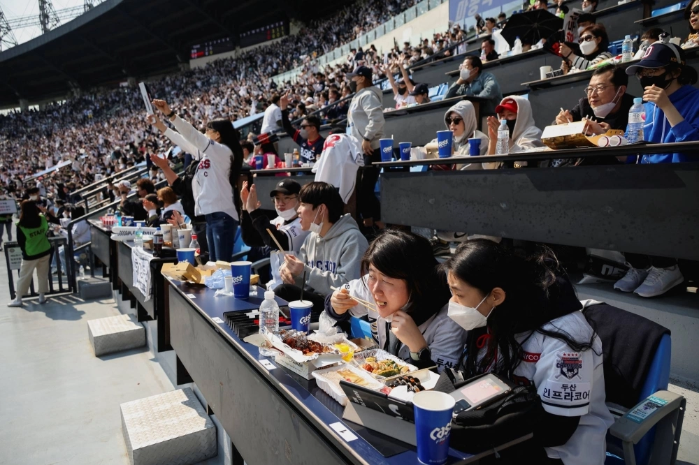 Fans during a game between the Hanwha Eagles and Doosan Bears at Jamsil Baseball Stadium in Seoul in April 2022.  Fans during a game between the Hanwha Eagles and Doosan Bears at Jamsil Baseball Stadium in Seoul in April 2022.