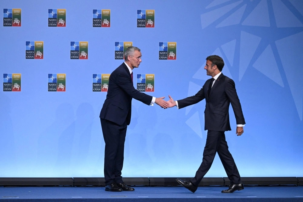 NATO Secretary General Jens Stoltenberg welcomes French President Emmanuel Macron at the NATO summit in Vilnius, Lithuania, in July 2023.  NATO Secretary General Jens Stoltenberg welcomes French President Emmanuel Macron at the NATO summit in Vilnius, Lithuania, in July 2023.