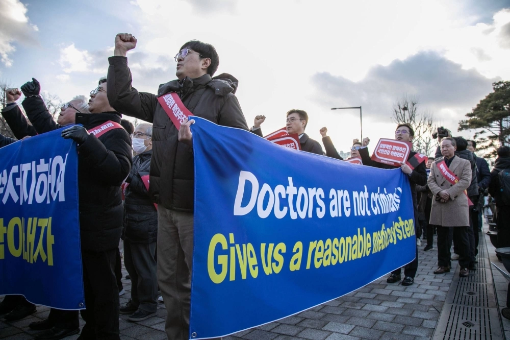 South Korean doctors and other demonstrators march during a protest in Seoul on Sunday. South Korean doctors and other demonstrators march during a protest in Seoul on Sunday.