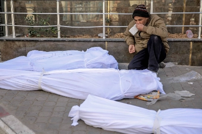 A man mourns at Shifa hospital in Gaza City on Thursday, looking over the bodies of Palestinians killed in an early morning incident when residents rushed toward aid trucks. A man mourns at Shifa hospital in Gaza City on Thursday, looking over the bodies of Palestinians killed in an early morning incident when residents rushed toward aid trucks.