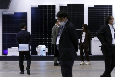 Solar panels on display at PV Expo in Tokyo on Wednesday. Japan's "transition bonds" will cover cutting-edge solar cells, as well as more controversial projects. Solar panels on display at PV Expo in Tokyo on Wednesday. Japan's "transition bonds" will cover cutting-edge solar cells, as well as more controversial projects.