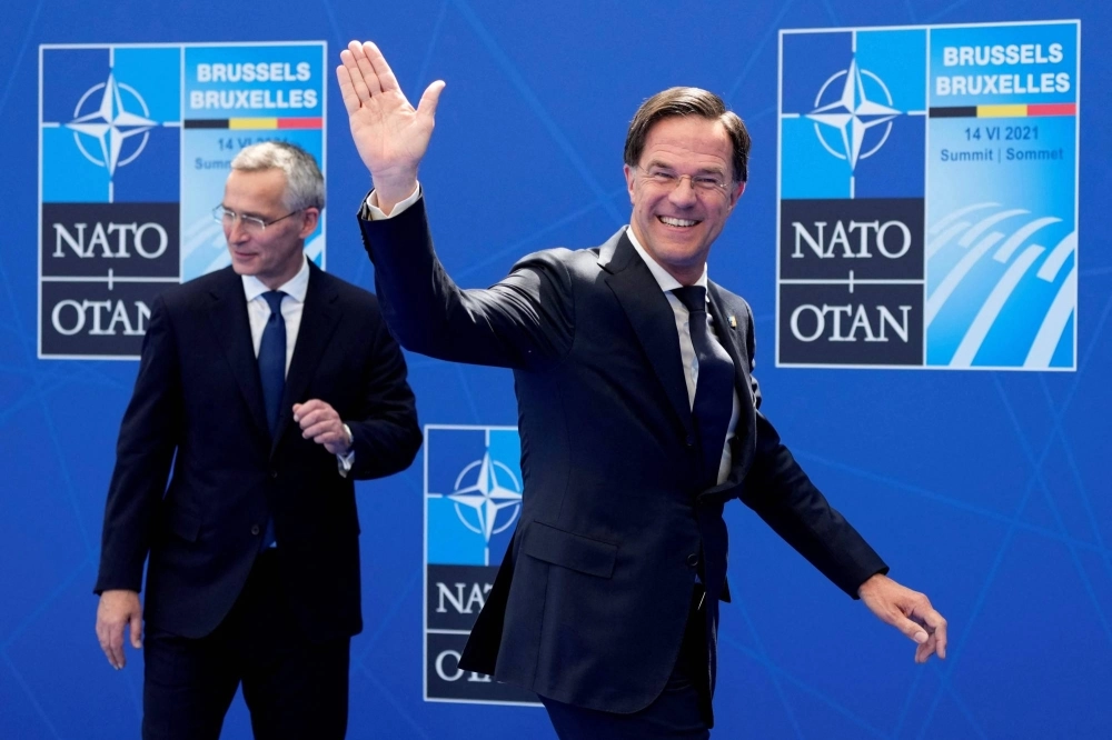 The Netherland's Prime Minister Mark Rutte waves as he walks past NATO Secretary-General Jens Stoltenberg during a summit at the alliance's headquarters in Brussels in June 2021. The Netherland's Prime Minister Mark Rutte waves as he walks past NATO Secretary-General Jens Stoltenberg during a summit at the alliance's headquarters in Brussels in June 2021.