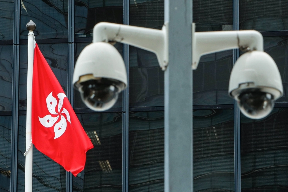 The Hong Kong flag and surveillance cameras outside the Central Government Offices in Hong Kong The Hong Kong flag and surveillance cameras outside the Central Government Offices in Hong Kong