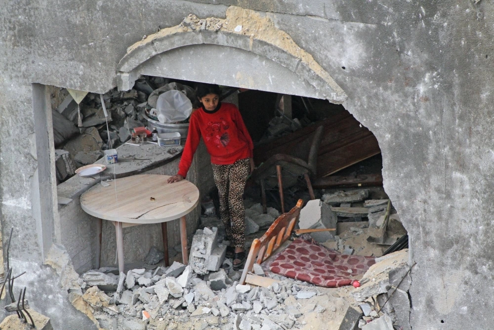 A Palestinian child stands in the remains of a building following an Israeli airstrike in a residential neighborhood of Deir al-Balah, in the Gaza Strip, on Thursday. A Palestinian child stands in the remains of a building following an Israeli airstrike in a residential neighborhood of Deir al-Balah, in the Gaza Strip, on Thursday.