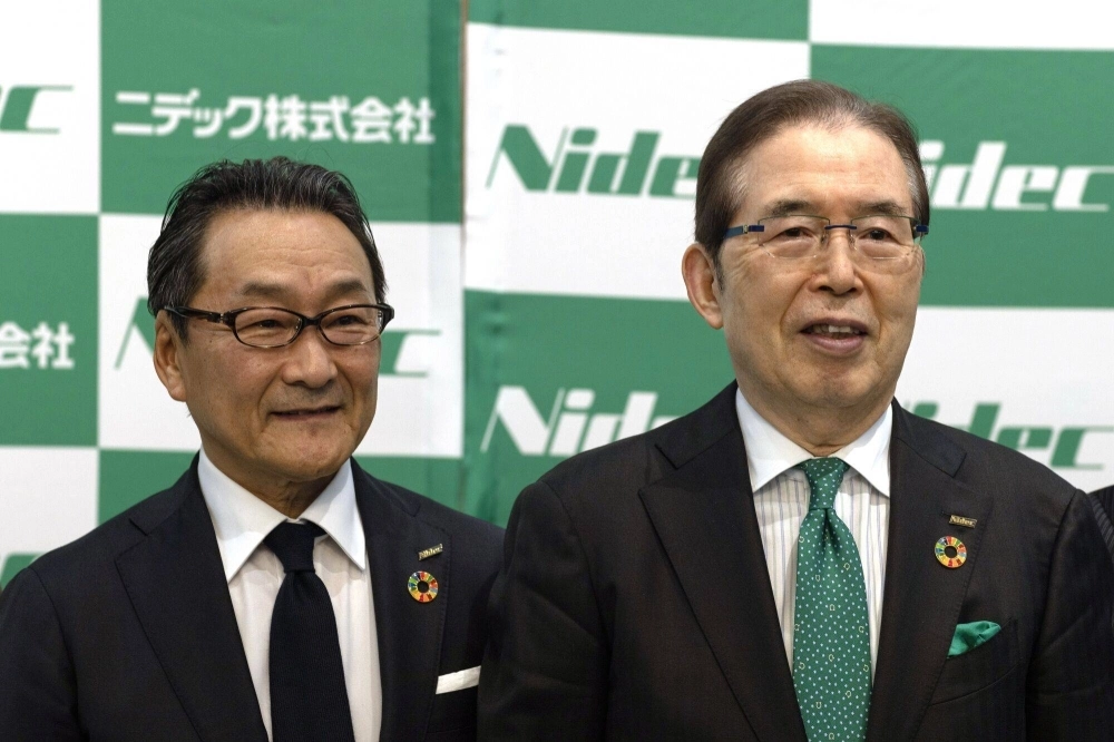 Mitsuya Kishida, incoming CEO of Nidec (left), and Shigenobu Nagamori, chairman and CEO, during a news conference at the company's headquarters in Kyoto on Feb. 14. Mitsuya Kishida, incoming CEO of Nidec (left), and Shigenobu Nagamori, chairman and CEO, during a news conference at the company's headquarters in Kyoto on Feb. 14.