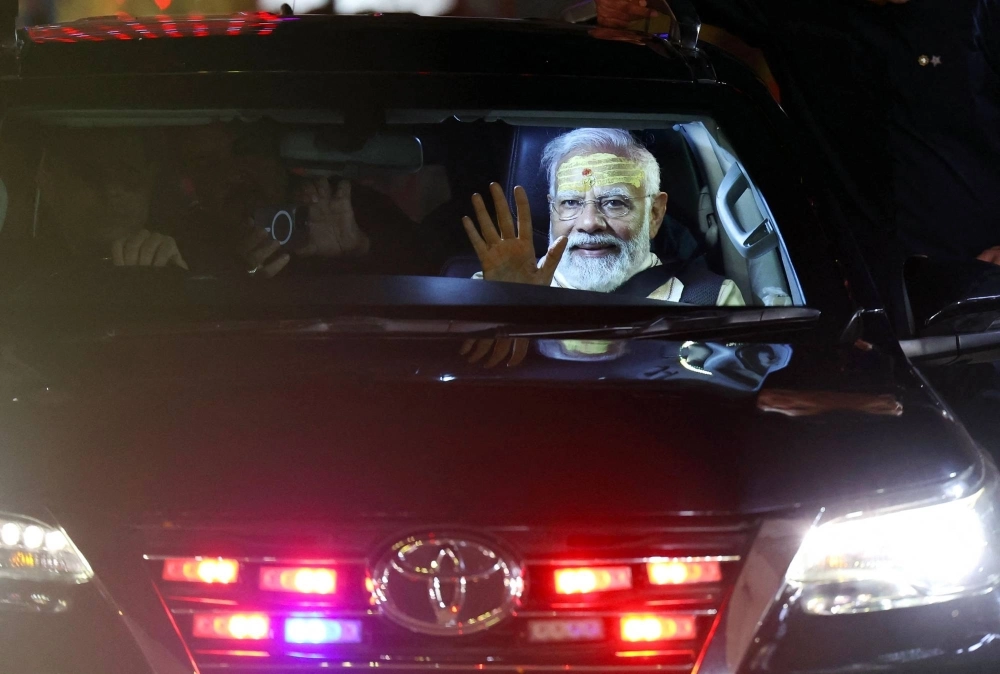 India's Prime Minister Narendra Modi waves to supporters from a car after offering prayers at the Kashi Vishwanath Hindu temple in Varanasi on Saturday. India's Prime Minister Narendra Modi waves to supporters from a car after offering prayers at the Kashi Vishwanath Hindu temple in Varanasi on Saturday.