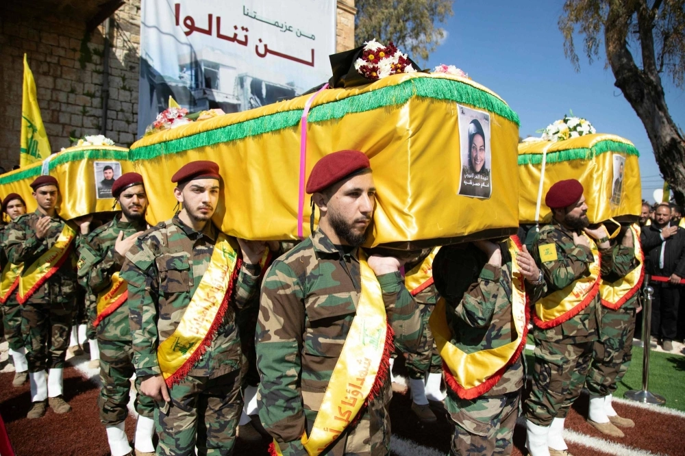 Hezbollah members take part in the funeral of four members of one family killed by in an Israeli air raid in southern Lebanon, on March 11 in Blida, near the border with Israel. Hezbollah members take part in the funeral of four members of one family killed by in an Israeli air raid in southern Lebanon, on March 11 in Blida, near the border with Israel.