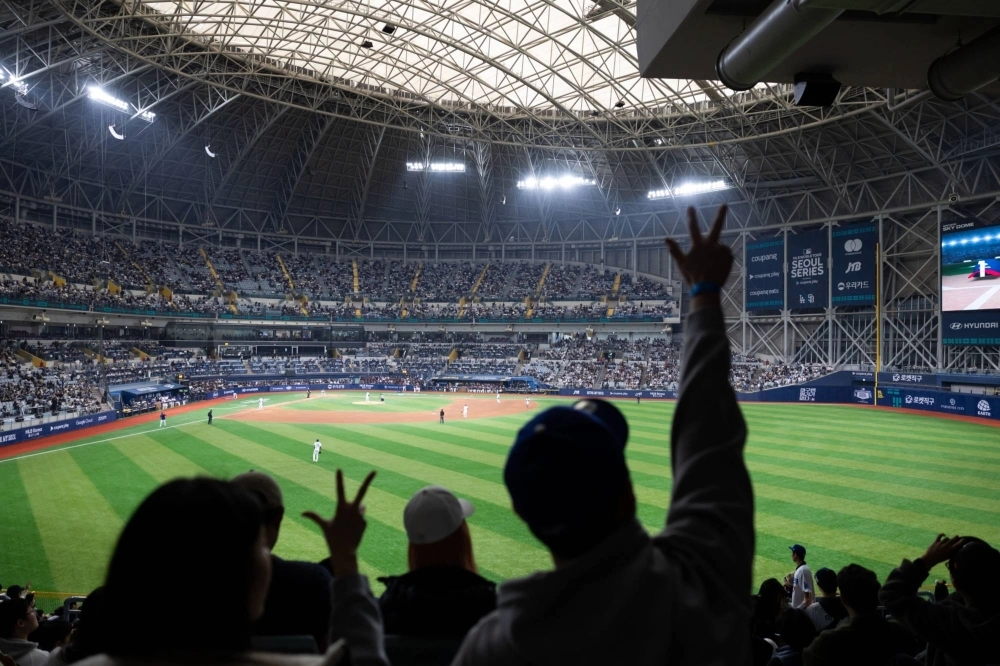 Fans cheer during a friendly match between the Los Angeles Dodgers and the Kiwoon Heroes ahead of the Major League Baseball Seoul Series in Seoul on Sunday. Fans cheer during a friendly match between the Los Angeles Dodgers and the Kiwoon Heroes ahead of the Major League Baseball Seoul Series in Seoul on Sunday.