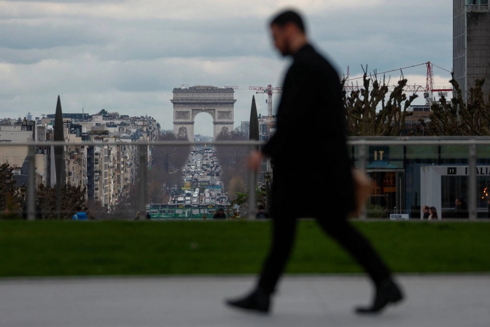 A man walks through the financial and business district of La Defense, near Paris, on March 13. A man walks through the financial and business district of La Defense, near Paris, on March 13.