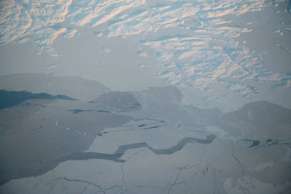 Ice forms on the window of an airplane heading from Iqaluit to Pond Inlet, Nunavut, Canada. The Earth's poles are warming faster than elsewhere, with the North Pole heating up about twice as fast as the rest of Earth for the last 30 years. Ice forms on the window of an airplane heading from Iqaluit to Pond Inlet, Nunavut, Canada. The Earth's poles are warming faster than elsewhere, with the North Pole heating up about twice as fast as the rest of Earth for the last 30 years.